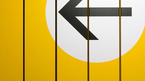 Minimalist Yellow Wall with Abstract Black Arrow Directional 4K Wallpaper