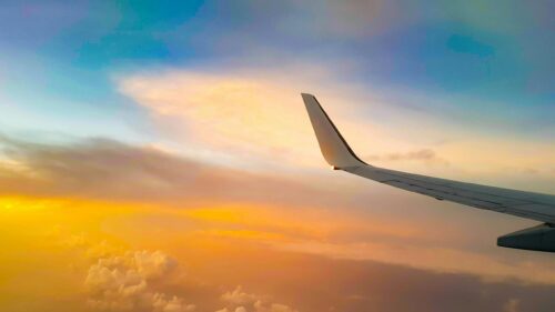 Dreamy Airplane Wing Sunset Above Clouds 4K Wallpaper