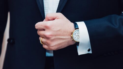 Elegant Man in Tuxedo with Luxury Watch and Gold Ring 4K Wallpaper
