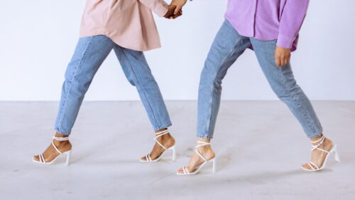Stylish Friends Holding Hands in High Heels Desktop Wallpaper