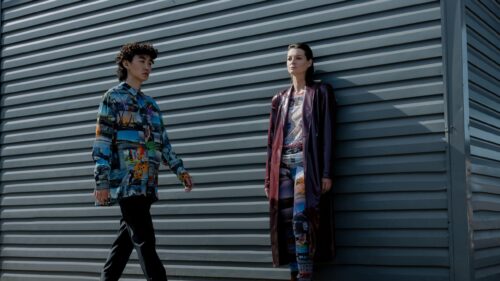 Fashion Models Standing Against Metal Siding Wall 4K Wallpaper