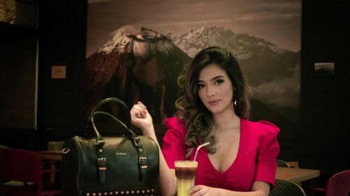 Elegant Woman in Red Dress with Black Handbag 4K Desktop Wallpaper