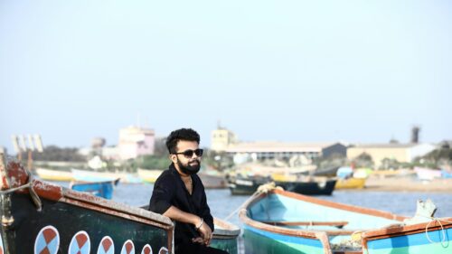Stylish Man Sitting on Fishing Boat at Harbor 4K Desktop Wallpaper