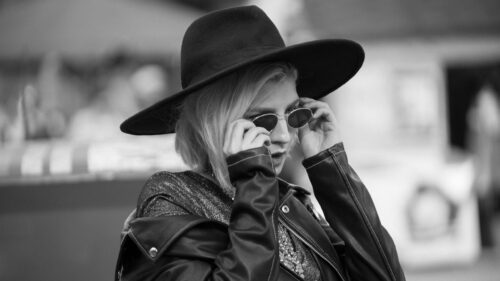 Stylish Woman in Leather Jacket and Fedora Hat Desktop Wallpaper