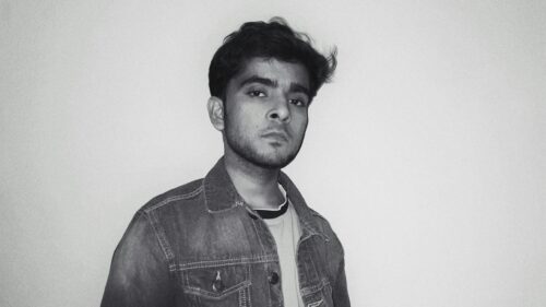 Serious Young Man in Denim Jacket Portrait 4K Wallpaper