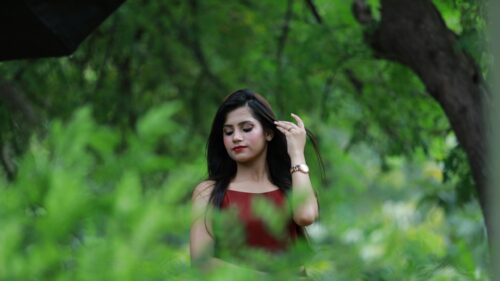 Beautiful Woman in Red Dress Amidst Lush Green Foliage Desktop Wallpaper