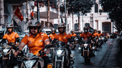 Motorcycle Parade Riders in Orange Uniforms 4K Desktop Wallpaper