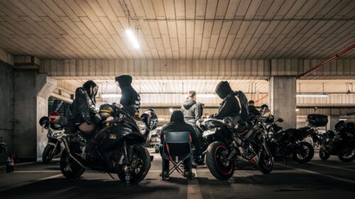 Group of Bikers in Dark Underground Parking Garage 4K Wallpaper