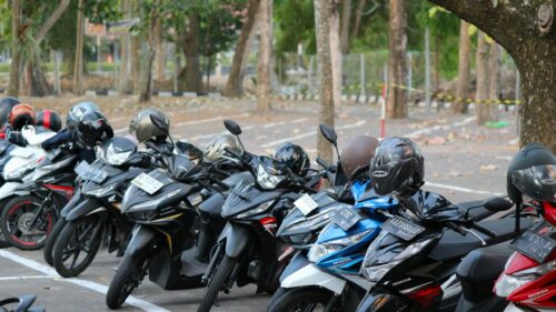 Row of Parked Honda Motorcycles in a Quiet Campus Setting Desktop Wallpaper
