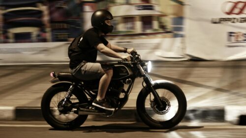 Lone Rider on a Custom Honda Cafe Racer at Night Desktop Wallpaper