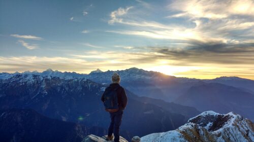 Lone Hiker Watching Sunrise Over Himalayan Peaks Desktop Wallpaper