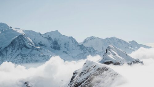 Snowy Alpine Mountain Peak Above Clouds 4K Desktop Wallpaper
