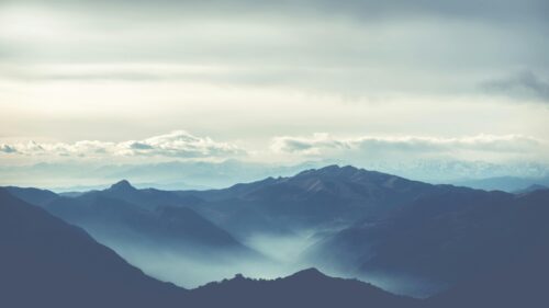 Breathtaking Blue Mist Over Mountain Ranges 4K Desktop Wallpaper
