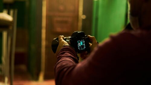 Cinematic Filmmaker Holding Camera Behind the Scenes PC Wallpaper