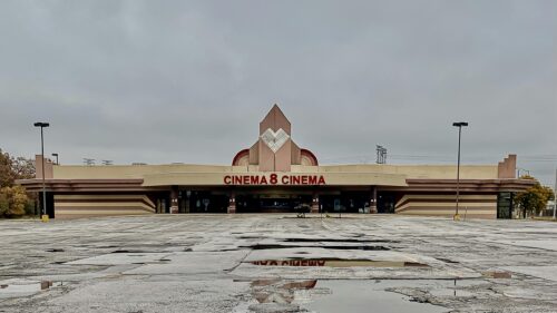 Abandoned Cinema 8 Building Exterior Under Cloudy Sky Desktop Wallpaper