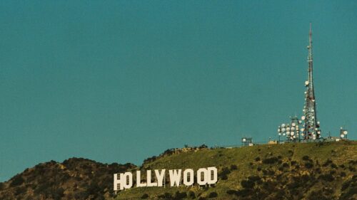 Iconic Hollywood Sign and Television Tower Under Clear Blue Sky 4K Wallpaper