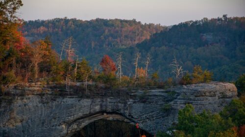 Natural Stone Arch in Autumn Forest at Sunset 4K Wallpaper
