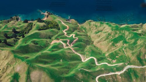 Aerial View of Winding Coastal Road Green Hills 4K Wallpaper