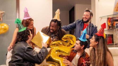 Group of Friends Celebrating Birthday Party with Golden Balloons 4K Wallpaper