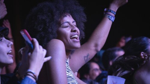 Joyful Woman Dancing at a Music Concert 4K Desktop Wallpaper