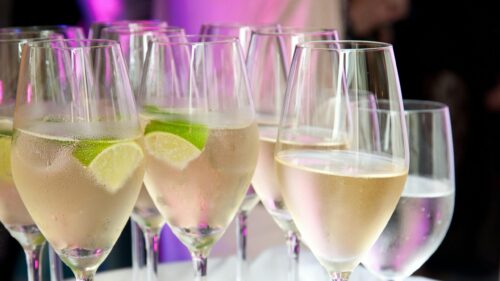 Elegant Glasses of Sparkling Wine with Lime Wedges 4K Wallpaper