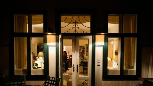 Cozy Evening House Exterior With Warm Interior Lighting 4K Wallpaper