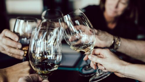 Friends Making a Wine Toast at Dinner Table 4K Wallpaper