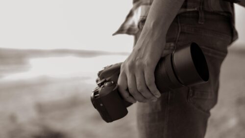 Professional Photographer Holding DSLR Camera Artistic 4K Wallpaper