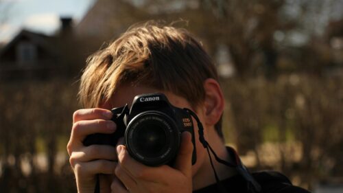 Young Photographer With Canon Camera Focus 4K Desktop Wallpaper