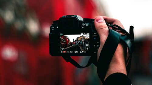 Cinematic Photographer POV Hand Holding Digital Camera Desktop Wallpaper