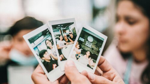 Hands Holding Polaroids of Family Memories Desktop Wallpaper