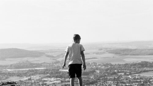 Little Boy Overlooking Vast Valley View Monochrome Desktop Wallpaper