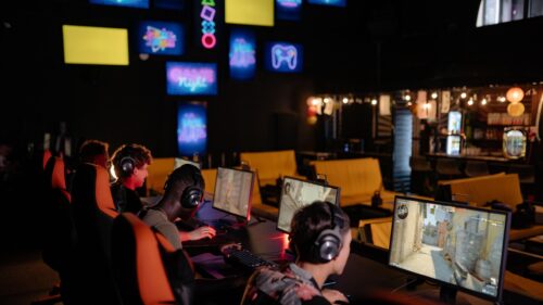 Immersive Esports Gaming Setup with Gamers at Monitors 4K Wallpaper