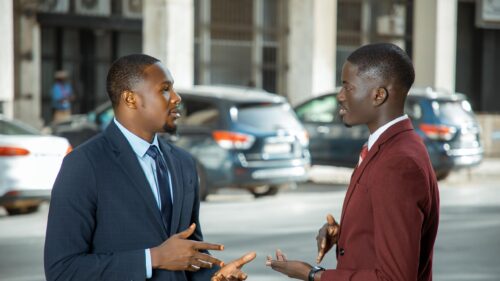 Two Professional Men Discussing Business in Suits Desktop Wallpaper