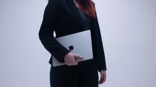 Professional Businesswoman Holding Laptop Minimalist 4K Wallpaper