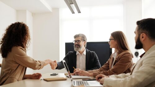 Business Professionals Shaking Hands During Office Meeting 4K Wallpaper