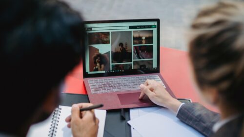 Creative Team Collaborating on Laptop Screen Design 4K Wallpaper