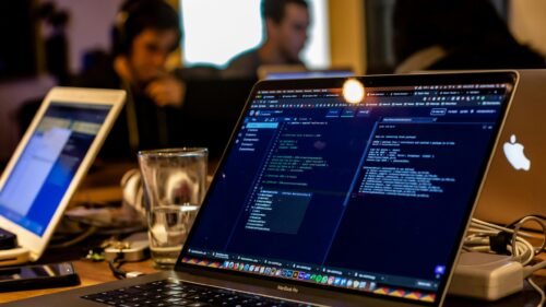Programming Setup with Code on Laptop Screen 4K Desktop Wallpaper