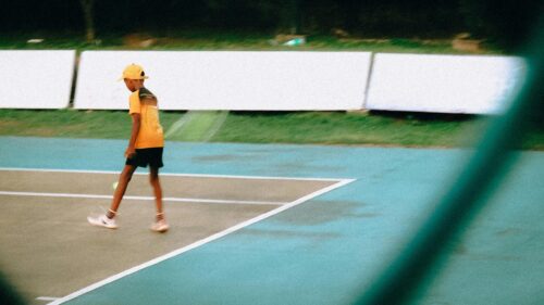 Young Tennis Player on Court Action Shot Desktop Wallpaper