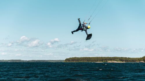Extreme Kitesurfer Mid-Air Jump Over Blue Sea 4K Wallpaper