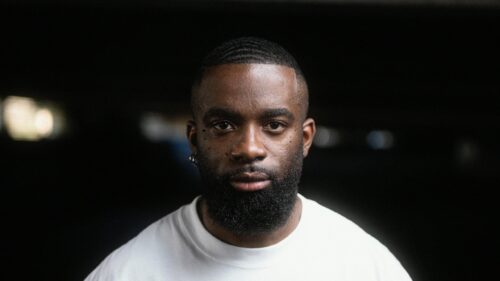 Cinematic Portrait of a Bearded Black Man in White T-Shirt 4K Wallpaper