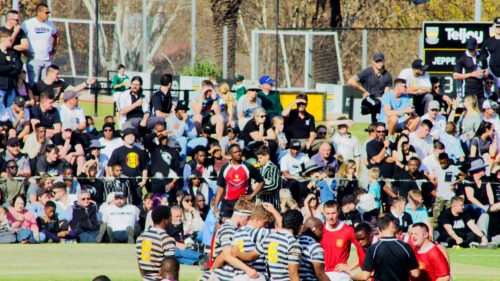 High School Rugby Match Action Crowd and Team Huddle Desktop Wallpaper