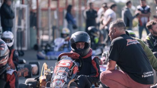 Young Kart Racer with Coach Preparing for Race 4K Wallpaper