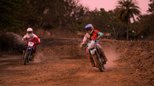 Two Motocross Riders Racing on Dirt Track 4K Wallpaper