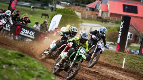 Intense Motocross Racing Action on Dirt Track 4K Wallpaper