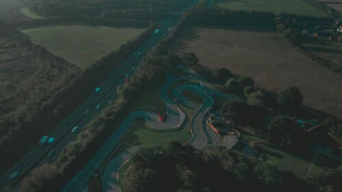 Aerial View of a Winding Go-Kart Racetrack Near a Highway 4K Wallpaper
