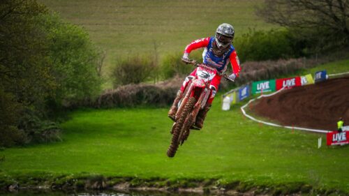 Motocross Rider Jumping Over Muddy Track Desktop Wallpaper