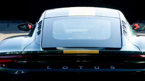 Rear View of Green Lotus Sports Car with Yellow Racing Stripe 4K Wallpaper
