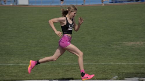 Young Female Athlete Sprinting in Pink Gear 4K Desktop Wallpaper
