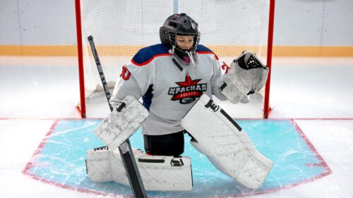 Young Hockey Goalie Protecting the Net 4K Wallpaper